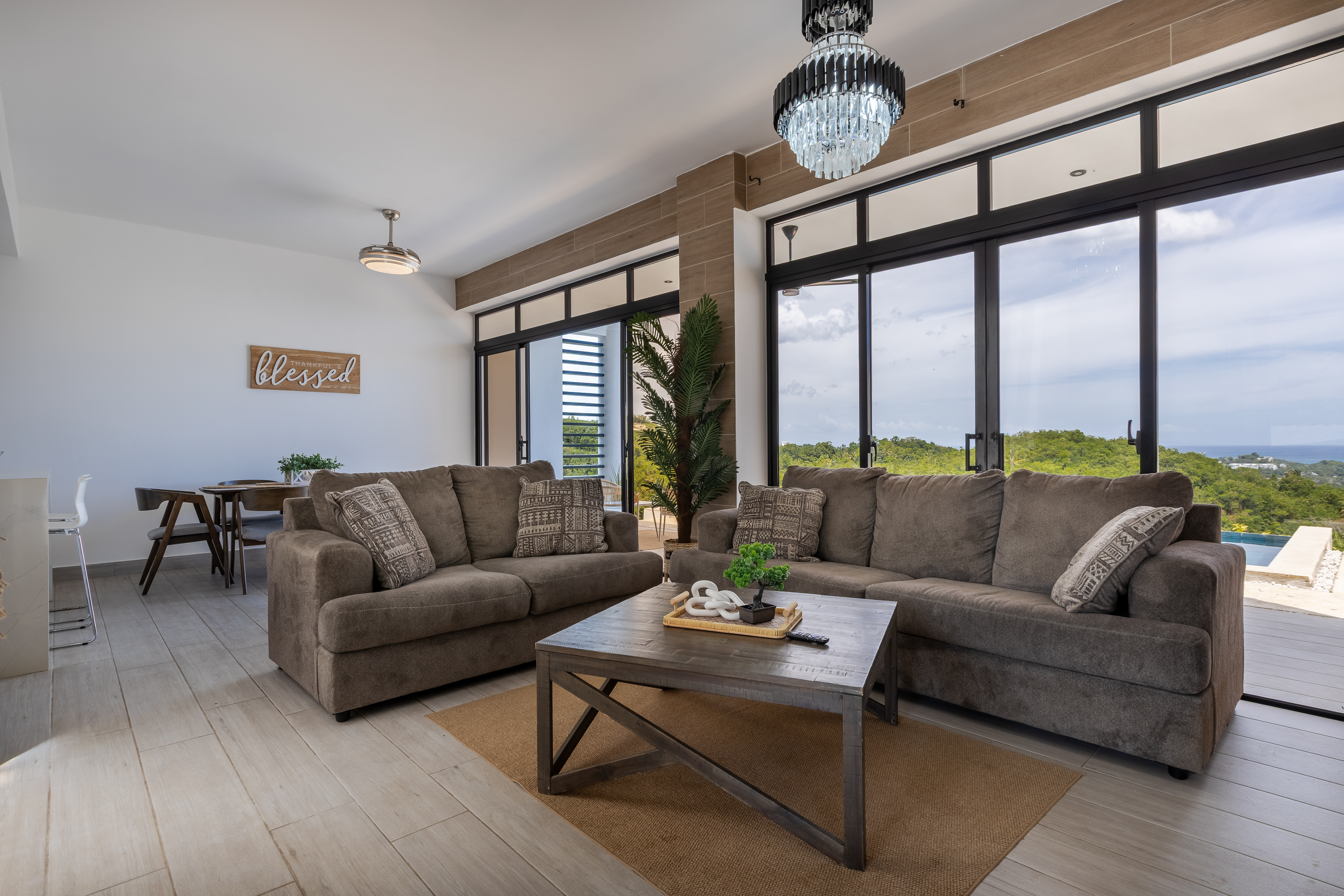 Living room with floor-to-ceiling sea views and crystal chandelier